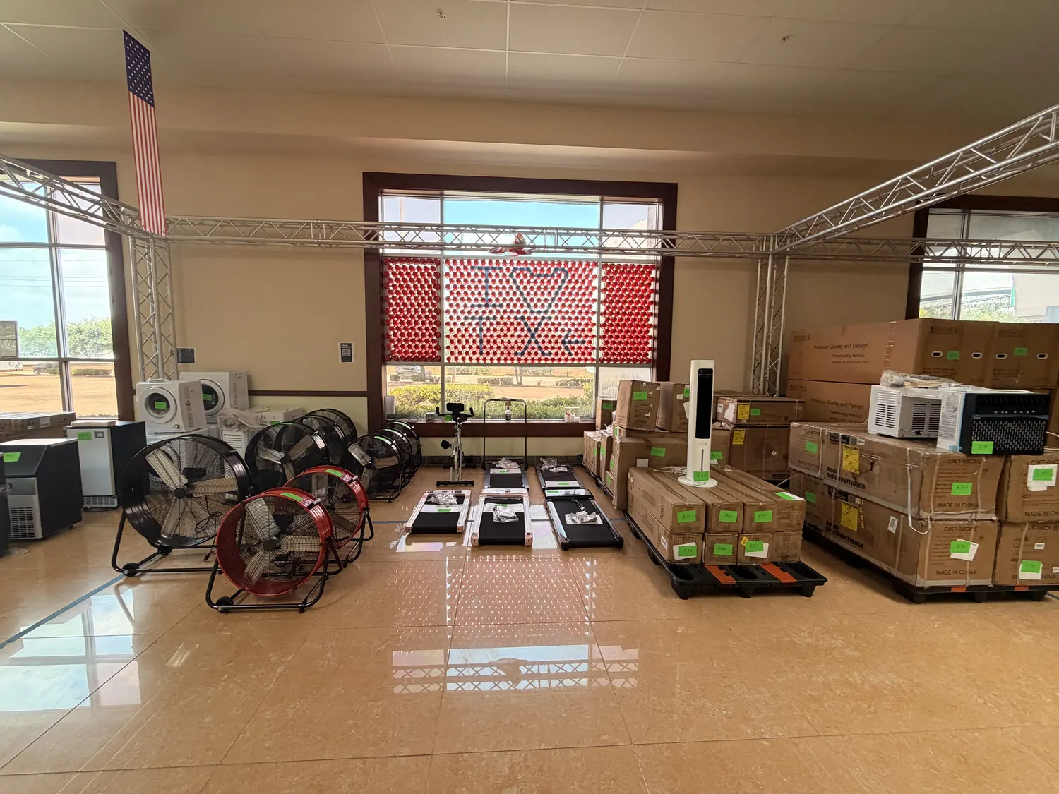 Cube-Age pop-up sale floor with drum fans, walking pads and pallets of window air conditioners