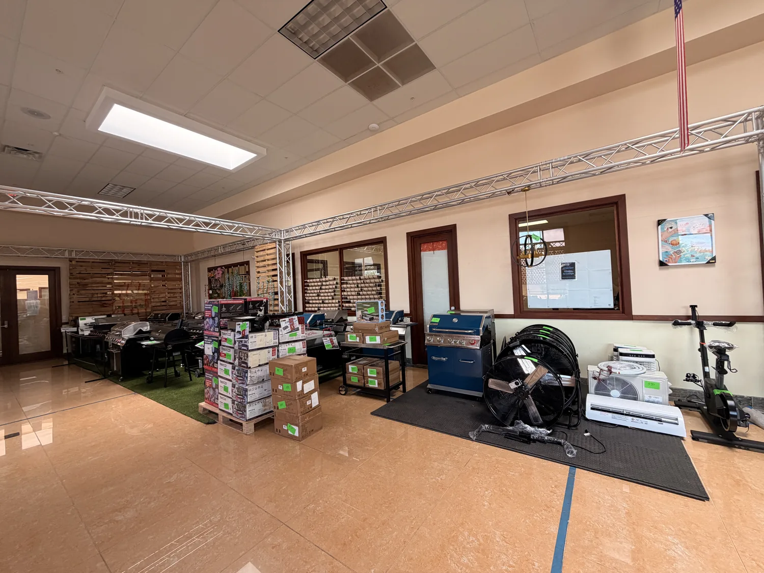 BBQ grills, mini-split air conditioners and exercise equipment staged for the pop-up sale
