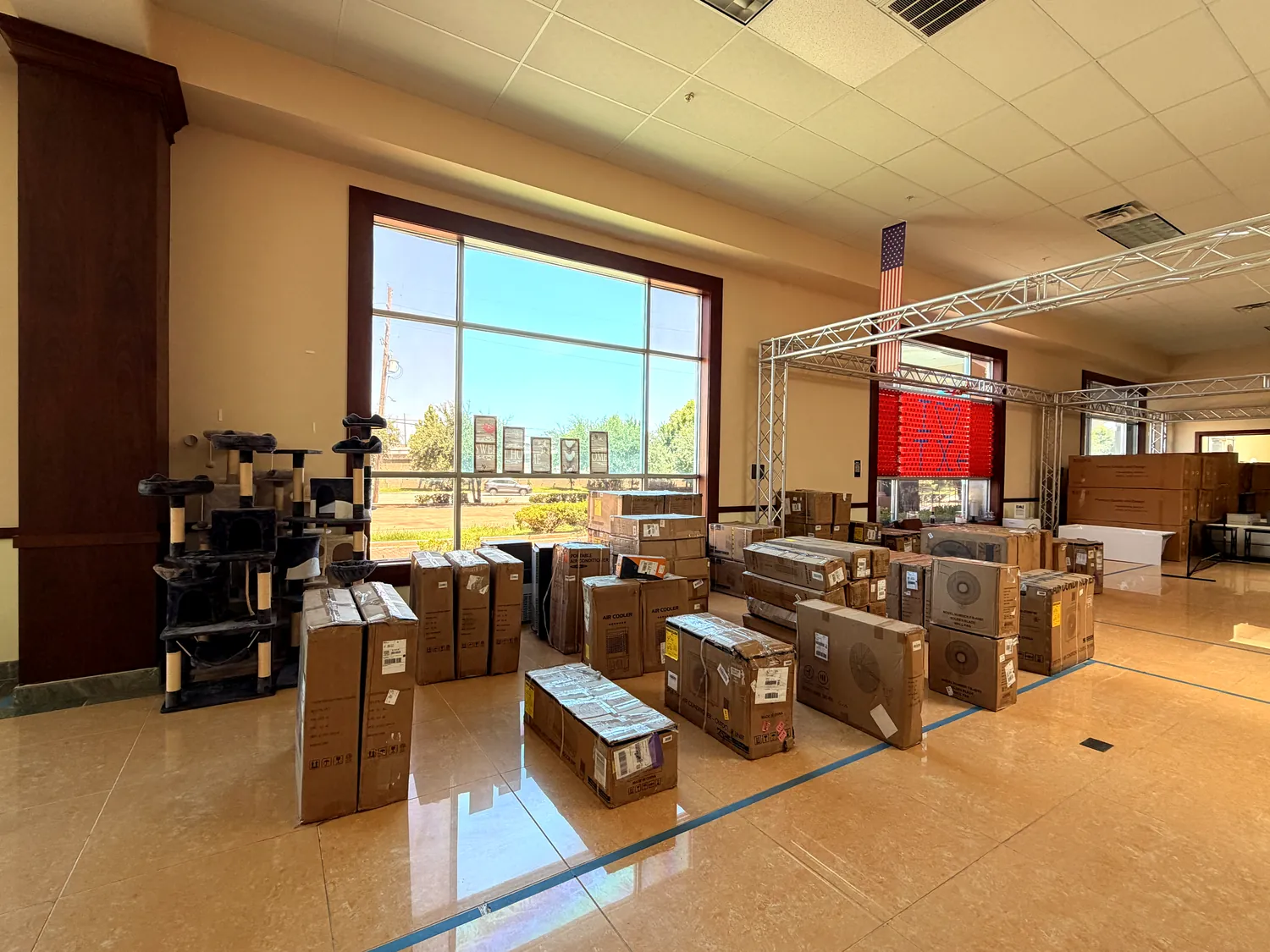 Goods staged by the window with taped booth layout