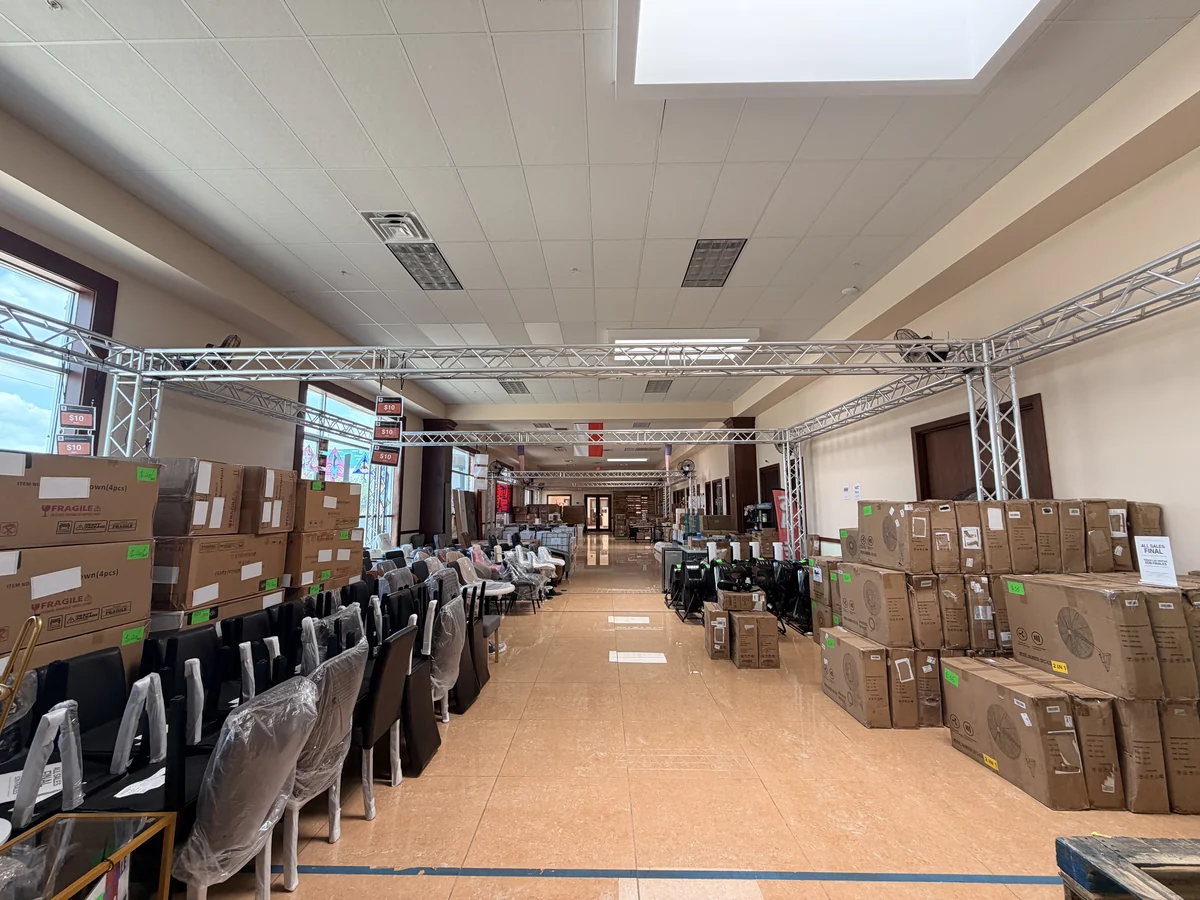 The main aisle of the Cube-Age Houston sale floor, set out and price-tagged