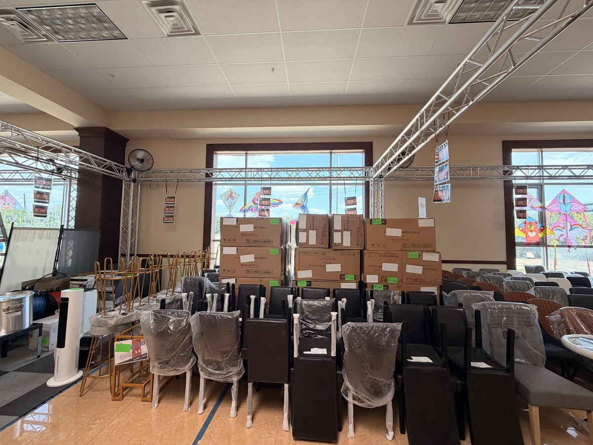 Rows of dining chairs wrapped and price-tagged on the sale floor