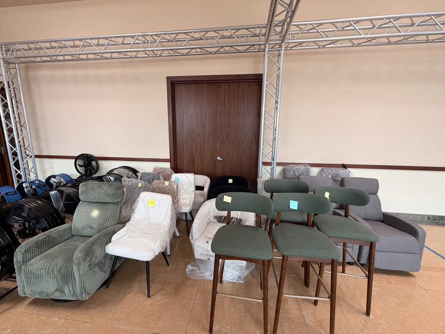 Armchairs, bar stools and sofas on the Cube-Age floor, several tagged sold