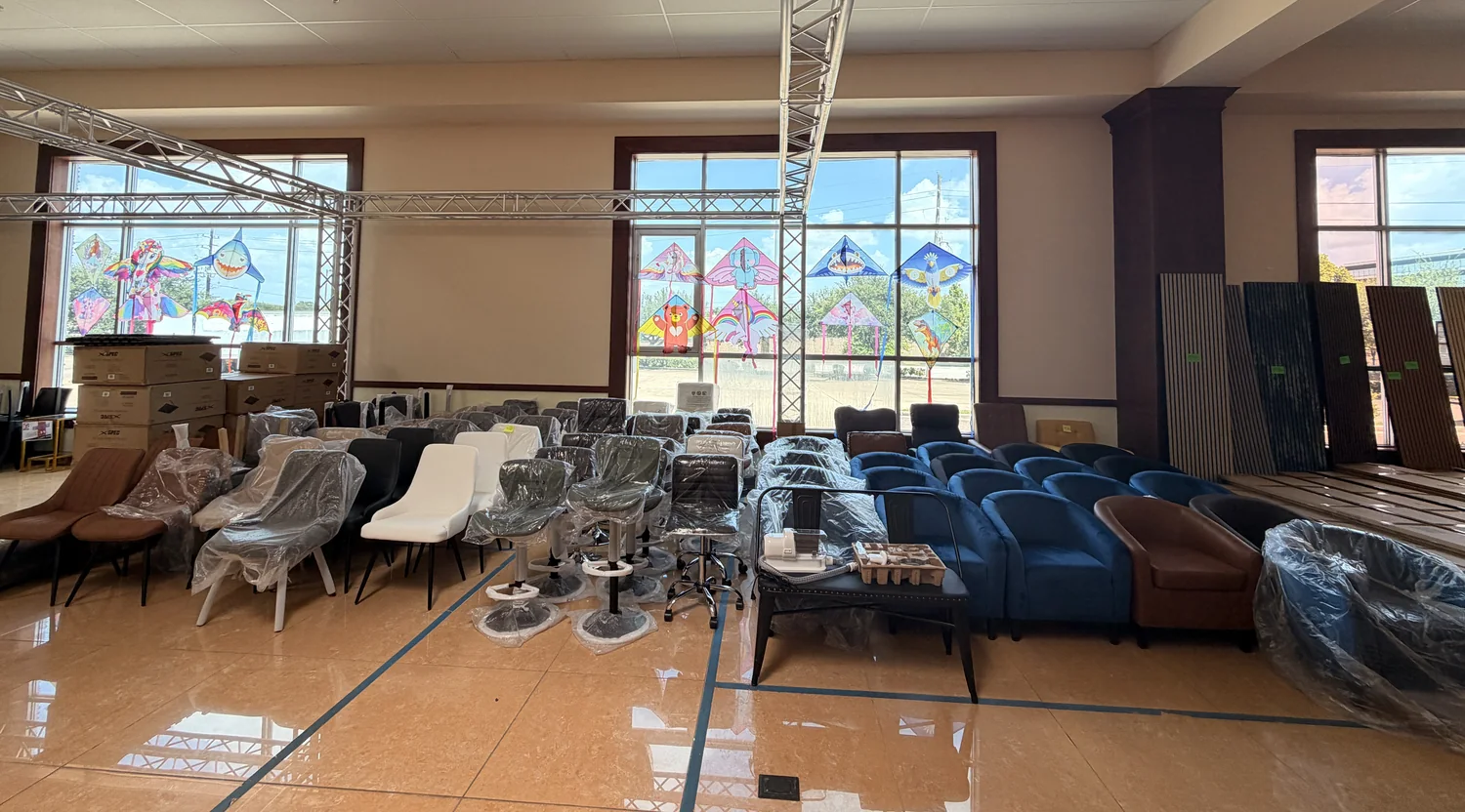 Rows of dining chairs, accent chairs and armchairs staged for the Cube-Age pop-up sale