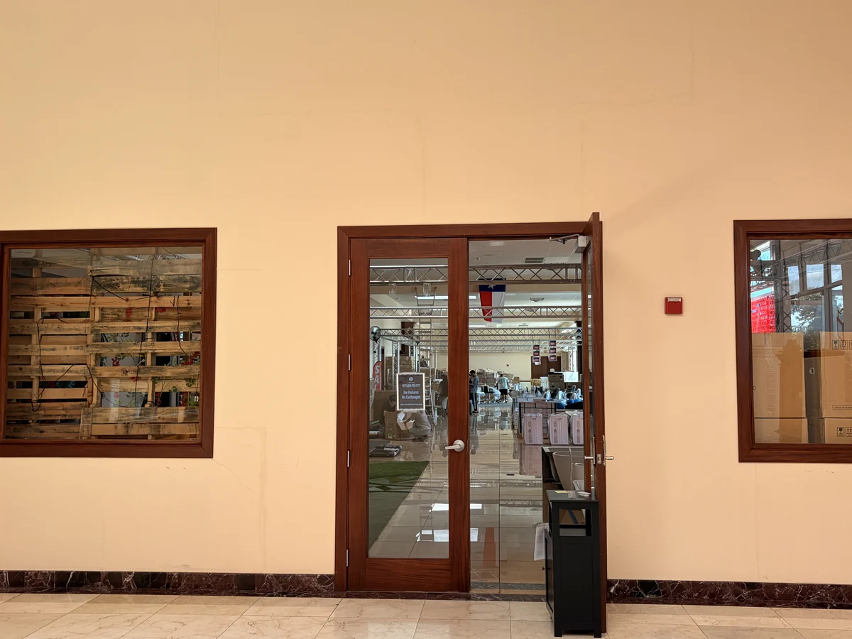 The wooden-framed glass doors leading into the Cube-Age showroom and sale floor