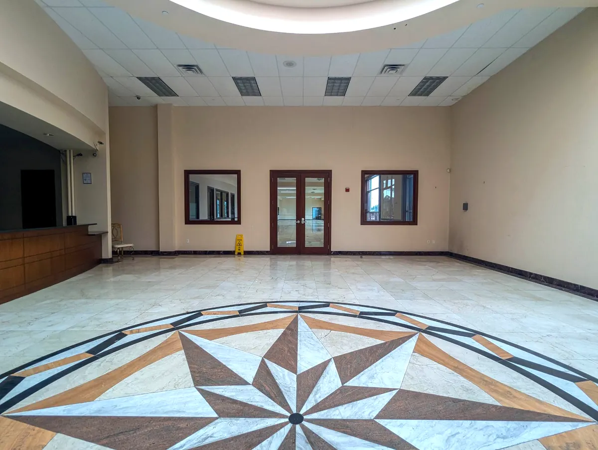 Cube-Age Houston event venue lobby with inlaid marble medallion floor