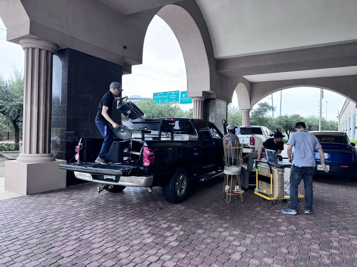 Three customer vehicles loading at the same time under the entrance arch of the Cube-Age Houston sale