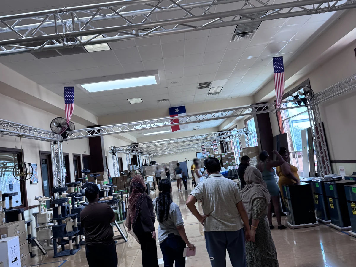 Buyers along the main aisle of the Cube-Age Houston sale floor on day three