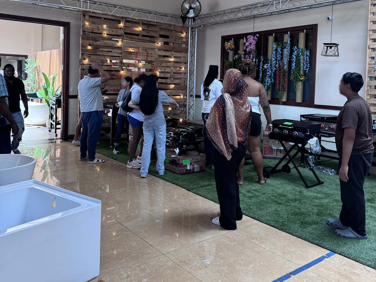 Customers around the griddles and gas grills on the Cube-Age Houston sale floor