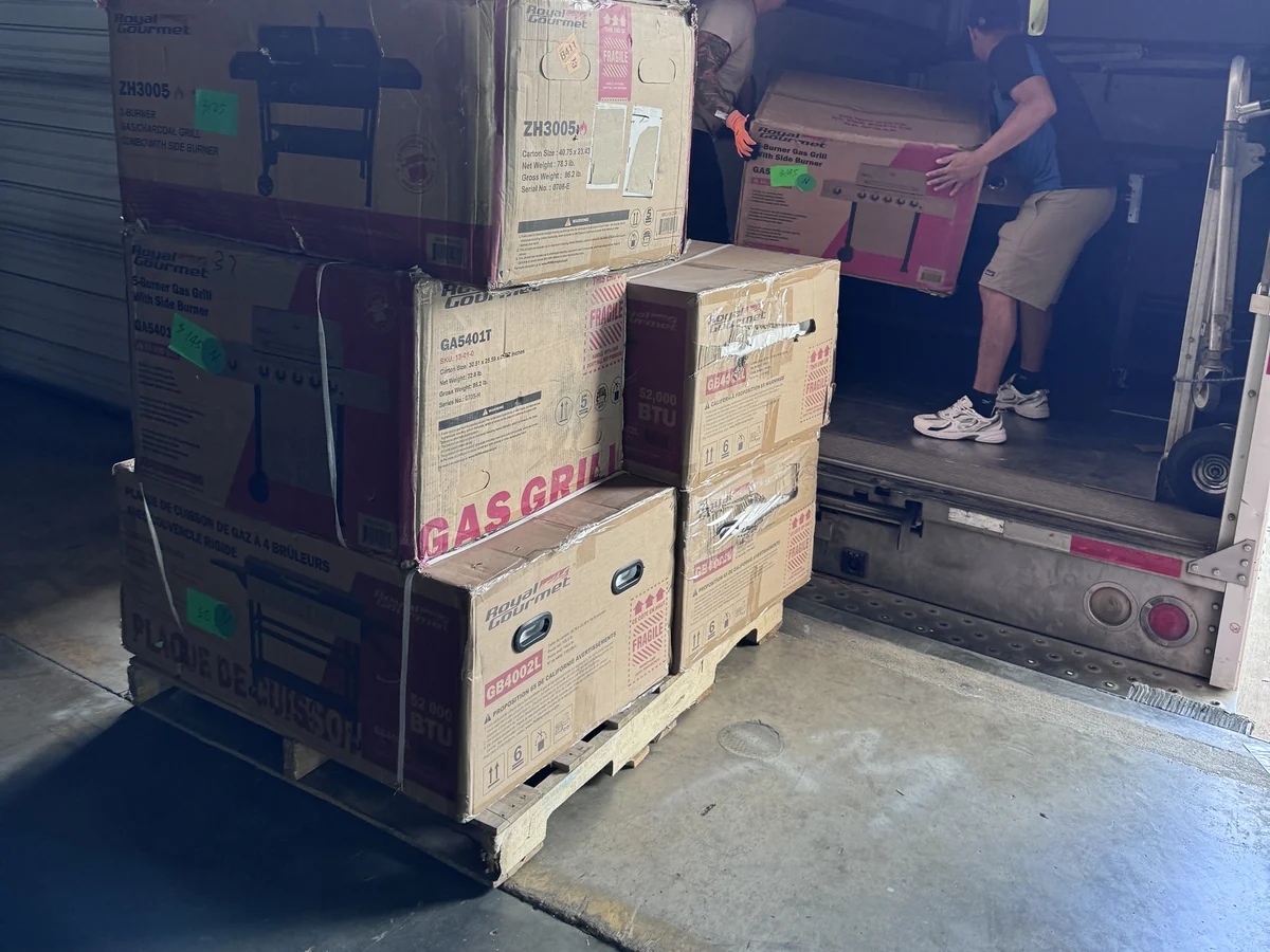 A pallet of sold, price-tagged Royal Gourmet gas grills on the back dock, a wholesale buyer order waiting to be loaded