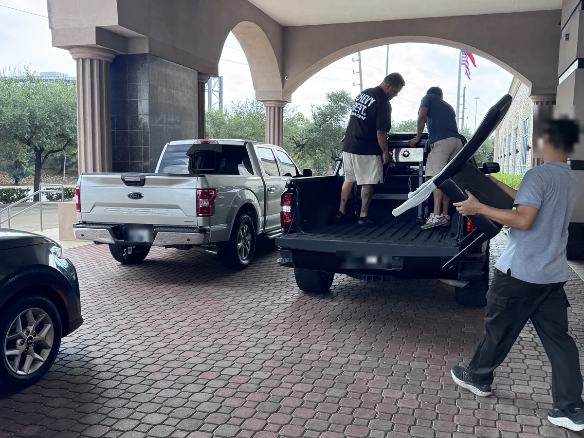 Two pickup trucks loading at the same time under the entrance arch of the Cube-Age Houston sale