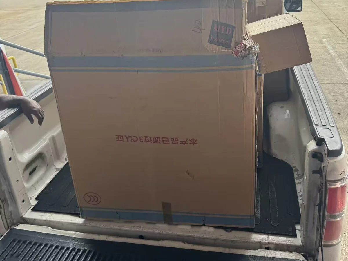 A large carton filling a pickup bed outside the Cube-Age Houston sale
