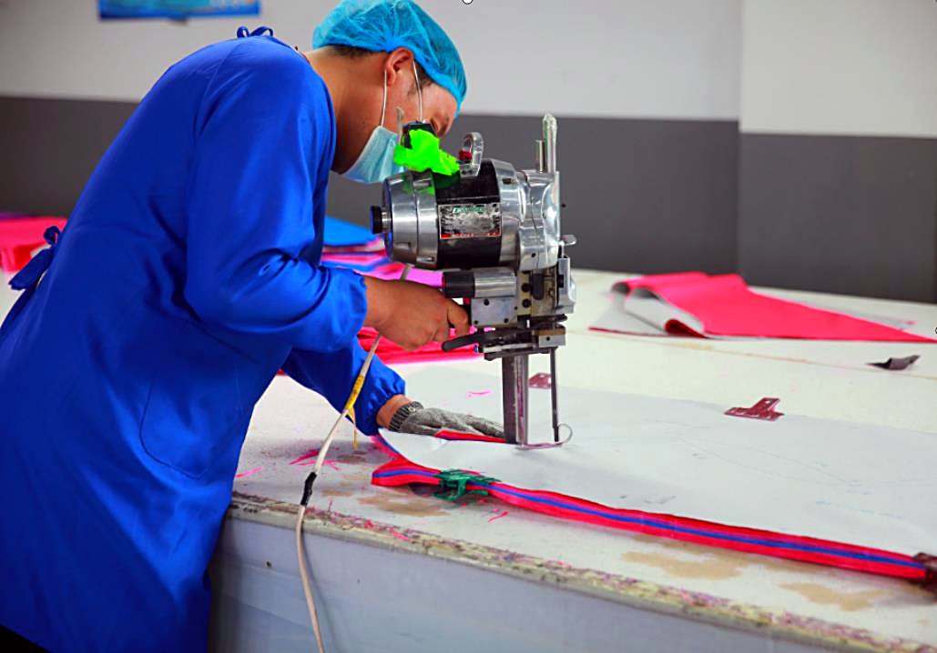 A hot knife cutting and sealing the edge of printed kite fabric in one pass