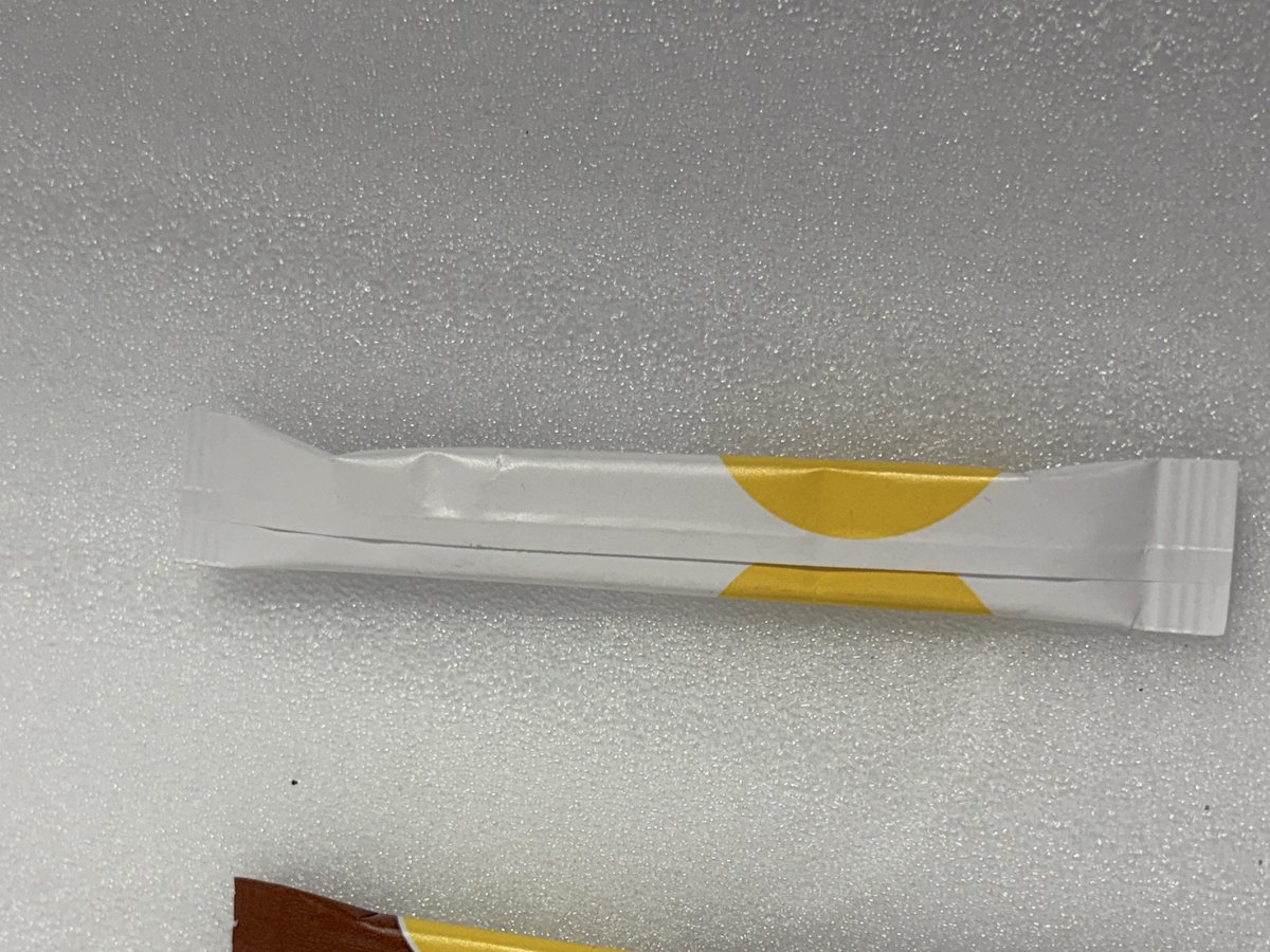 A single-serve stick of white cane sugar