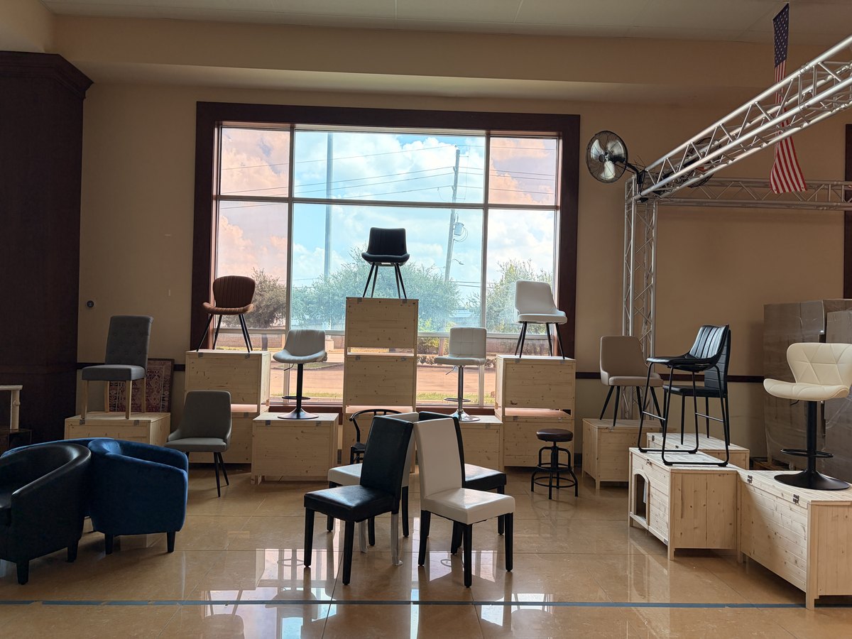 The finished seating zone in the Cube-Age showroom: dining chairs, bar stools and armchairs displayed on wooden risers